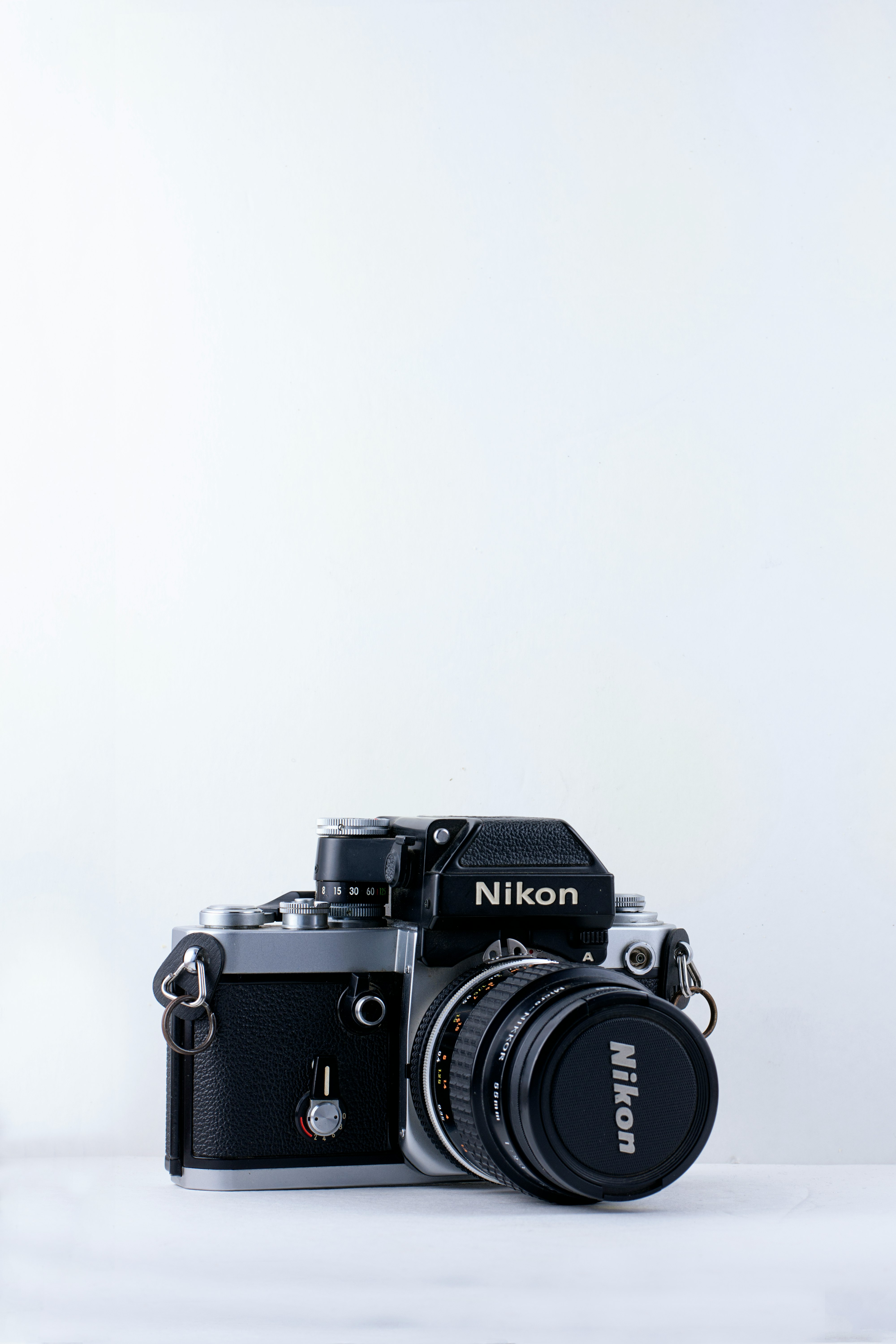 black Nikon camera against white background